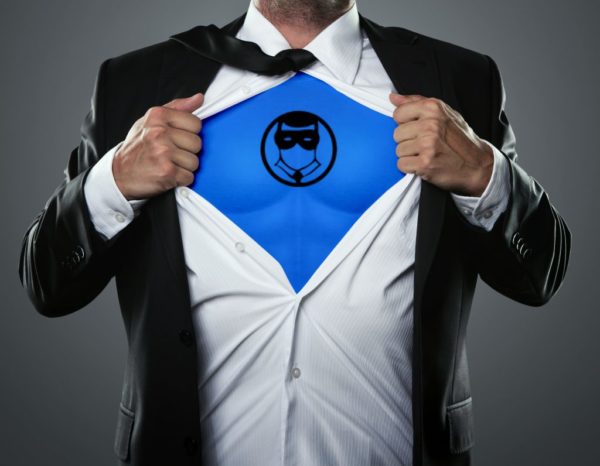 Revealing the superhero within: a person in a suit opening their shirt to display a symbol on the chest, signifying hidden strength and alter ego.